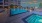 Spacious sparkling pool with sundecks and cabanas for lounging.